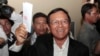 FILE PHOTO - Opposition Cambodia National Rescue Party President Kem Sokha shows off his ballot before voting in local elections in Chak Angre Leu on the outskirts of Phnom Penh, Cambodia, Sunday, June 4, 2017. 