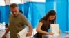 People cast their ballots during voting in a presidential election at polling station in Kyiv, May 25, 2014.