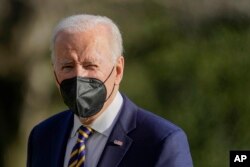 President Joe Biden walks on the South Lawn of the White House after stepping off Marine One, Feb. 10, 2022, in Washington.
