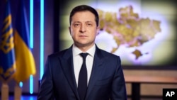 In this photo provided by the Ukrainian Presidential Press Office, Ukrainian President Volodymyr Zelenskyy addresses the nation on a live TV broadcast in Kyiv, Ukraine, Tuesday, Feb. 22, 2022. (Ukrainian Presidential Press Office via AP)