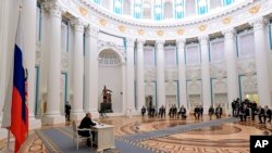 Russian President Vladimir Putin, left, chairs a Security Council meeting in the Kremlin in Moscow, Russia, Feb. 21, 2022.