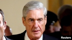 FILE - Special Counsel Robert Mueller leaves after briefing members of the U.S. Senate on his investigation into potential collusion between Russia and the Trump campaign on Capitol Hill in Washington.