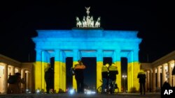 The Brandenburg Gate in Berlin, Germany, is illuminated in the colors of the Ukrainian flag to show solidarity with the country as Russia launches a military operation, Feb. 23, 2022.
