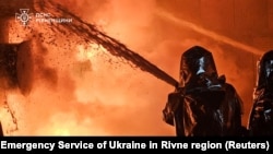 Firefighters work at the site of an energy infrastructure facility hit by a Russian drone strike, amid Russia's attack on Ukraine, in Rivne region, Ukraine, Dec. 3, 2024.