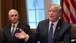 President Donald Trump, right, sitting next to Vice President Mike Pence, left, speaks in the Cabinet Room of the White House in Washington, April 9, 2018, at the start of a meeting with military leaders. 
