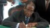 FILE - President Robert Mugabe signs Zimbabwe's new constitution into law in Harare, May 22, 2013.