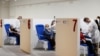 FILE - Women receive the Moderna vaccine against the coronavirus disease at the Music Auditorium in Rome, Italy, April 14, 2021. 