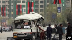 FILE - Security personnel inspect the site of a bomb attack in Kabul, Afghanistan, March 15, 2021.