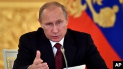 FILE - Russian President Vladimir Putin heads the Human Rights Council in Moscow's Kremlin, Russia, October 2014.