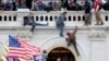 FILE PHOTO: A mob of supporters of U.S. President Donald Trump fight with members of law enforcement at a door they broke open as they storm the U.S. Capitol Building in Washington. January 6, 2021. 