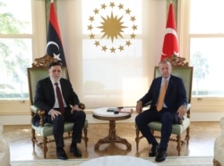 Turkey's President Recep Tayyip Erdogan, right, and Fayez Sarraj, the head of Libya's internationally-recognized government, pose together prior to their official talks in Istanbul, Sept. 6, 2020.