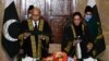 This handout photograph taken on Jan. 24, 2022, released by the Pakistan’s Press Information Department, shows chief justice Gulzar Ahmed
administering the oath to justice Ayesha Malik, in Islamabad. (Photo by Pakistan Press Information Department/AFP)