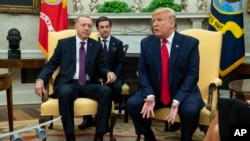 FILE - President Donald Trump meets with Turkish President Recep Tayyip Erdogan in the Oval Office of the White House, Nov. 13, 2019, in Washington. 