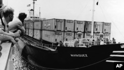FILE - In this May 1975 file photo, the destroyer escort USS Harold E. Holt prepares to tow the United States owned cargo vessel SS Mayaguez on May 1975. When the merchant ship Mayaguez and its American crew were seized by communist forces off the coast of Cambodia in 1975, the Ford administration was determined to craft a muscular response in hope of limiting damage to U.S. prestige, according to newly declassified documents published by the State Department. (AP Photo/ U.S. Navy, File)