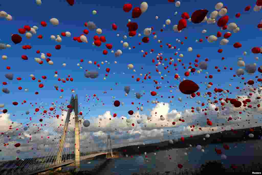 Red and white balloons are released during the opening ceremony of the newly built Yavuz Sultan Selim bridge, the third bridge over the Bosphorus linking the city's European and Asian sides in Istanbul, Turkey.