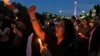 FILE - Activists hold a vigil for a teenage girl who was raped and murdered, in Jakarta, Indonesia, May 4, 2016.