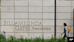 FILE - A person walks by the headquarters of the Bill and Melinda Gates Foundation in Seattle, Washington, April 27, 2018. 