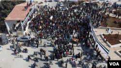 After ten years of war, protesters still gather in 'Seven Lakes' roundabout to call for the fall of the government on Feb. 26, 2021 in Idlib, Syria. (Mohammad Daboul/VOA)