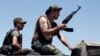 Lebanese army soldiers sit on top of a military truck as reinforcements arrive to the outskirts of Arsal, a predominantly Sunni Muslim town near the Syrian border in eastern Lebanon, Aug. 4, 2014. 