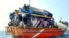 FILE - Sri Lankan asylum seekers stay on their traditional boat near Dili's port.