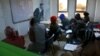 Syrian refugees are seen through a window attending an English language class, at a multi-service center for Syrian refugees in Gaziantep, Turkey, April 22, 2015. 