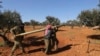 Rebel fighters prepare to fire a missile towards Syrian government positions in the province of Idlib, Feb. 9, 2020.