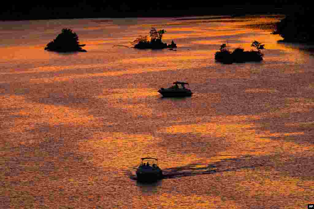 Recreational boaters cruise along the Potomac River at sunset near the Georgetown neighborhood in Washington, D.C., Aug. 30, 2016.