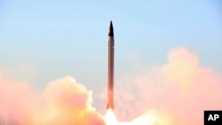 FILE - This picture released by the official website of the Iranian Defense Ministry on Oct. 11, 2015, claims to show the launching of an Emad long-range ballistic surface-to-surface missile in an undisclosed location.