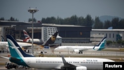 Pesawat Silk Air dan beberapa pesawat lain di Bandara Changi, Singapura, 12 Maret 2018.