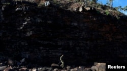 An indigenous soldier is seen in Australia's Northern Territory July 18, 2013. A mining company was fined for damaging a nearby Aboriginal site.